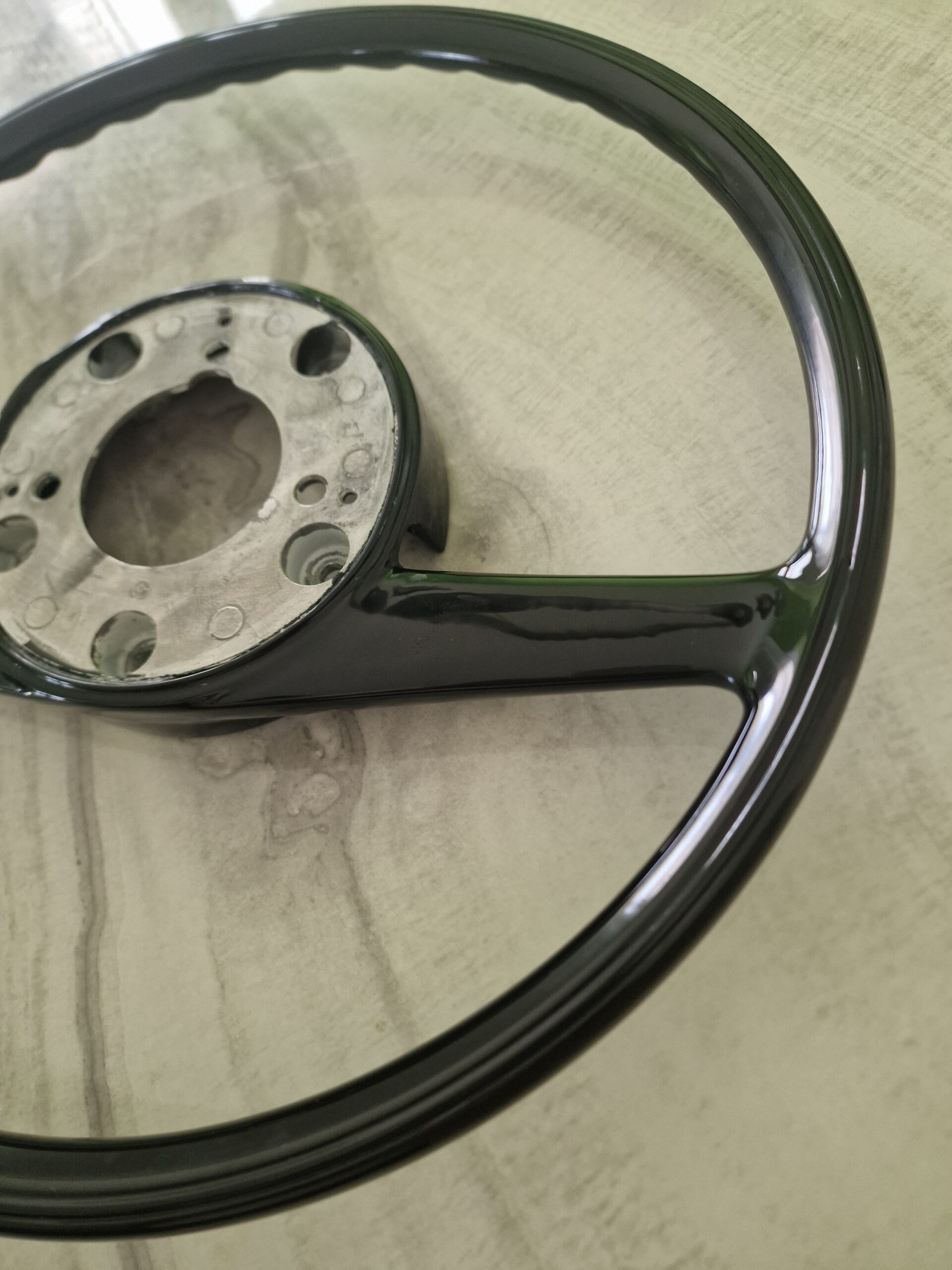A pristine, expertly polished vintage Bakelite component brought back to its original splendor by Pride Car Customs.