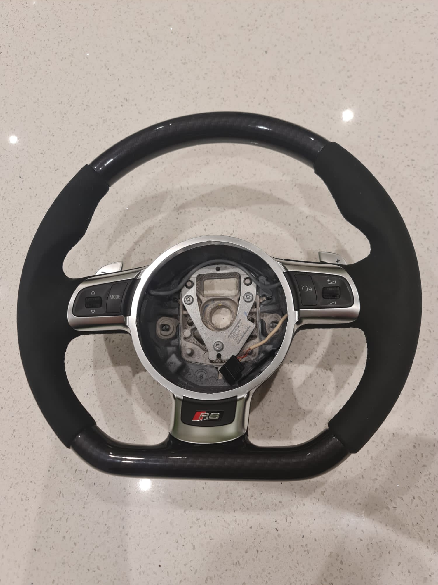 Fully restored Audi R8 steering wheel featuring premium matte leather and carbon fibre look.