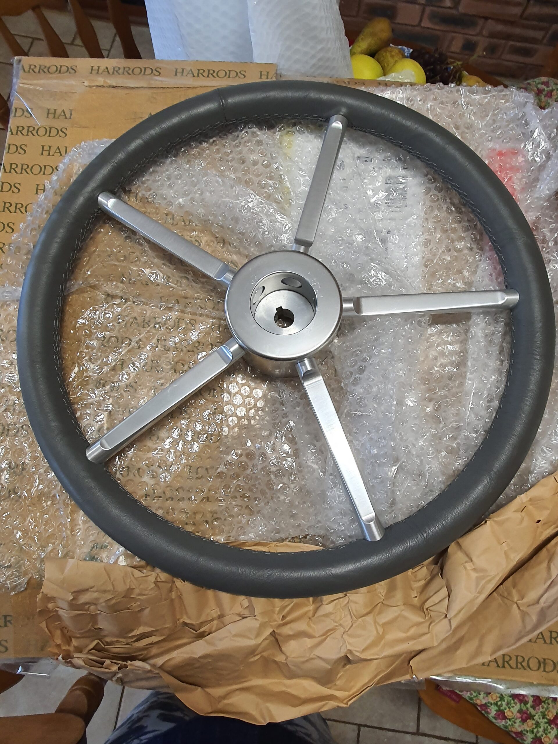 Re-upholstered luxury boat steering wheel finished by Pride Car Customs.