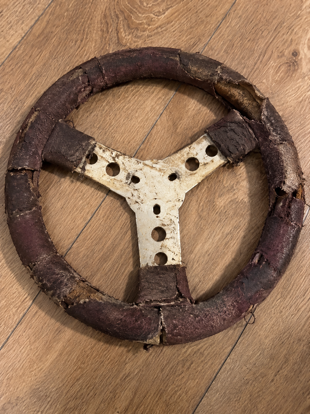 Worn and damaged go-kart steering wheel before refurbishment