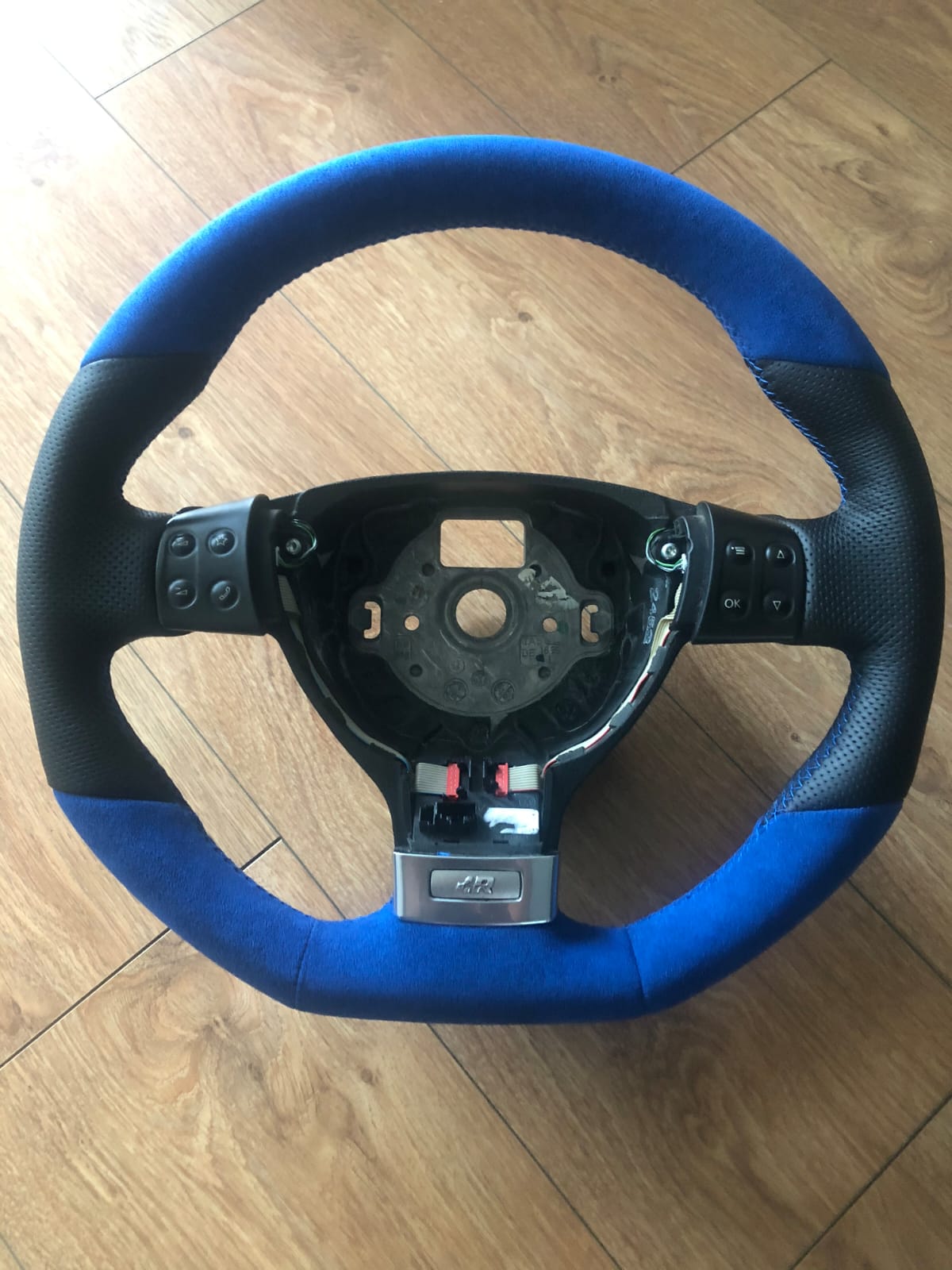 Fully restored Golf R steering wheel with a factory-fresh blue alcantara and black leather finish and clean blue stitching.